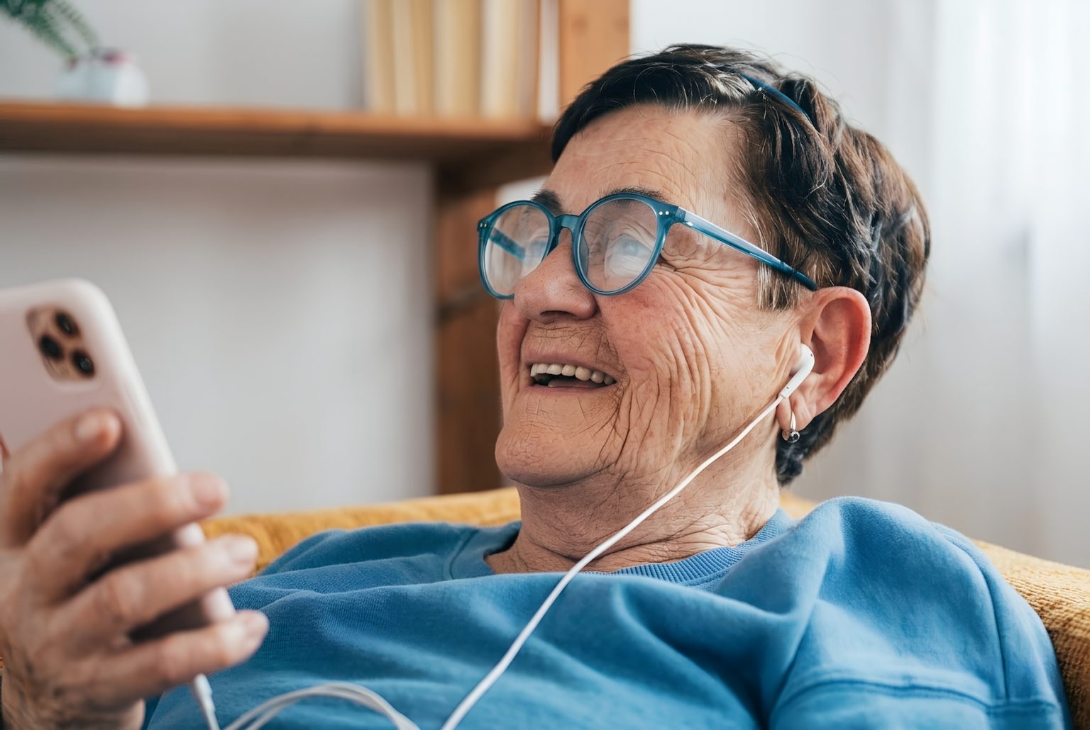 woman-senior-sitting-phone-smiling-SM