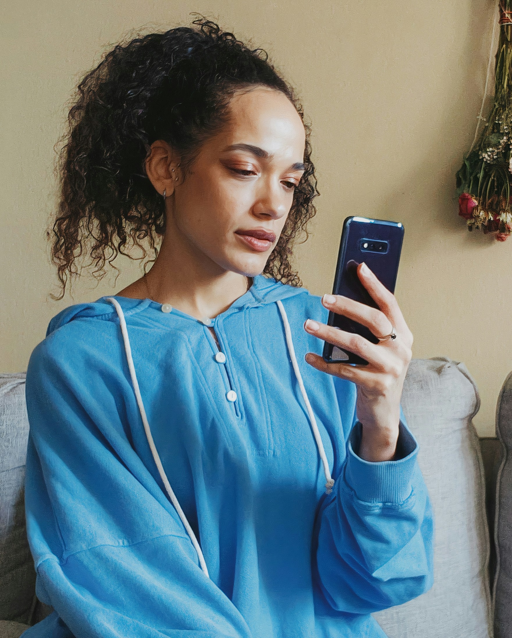 A patient reviewing a medical bill on her phone at home